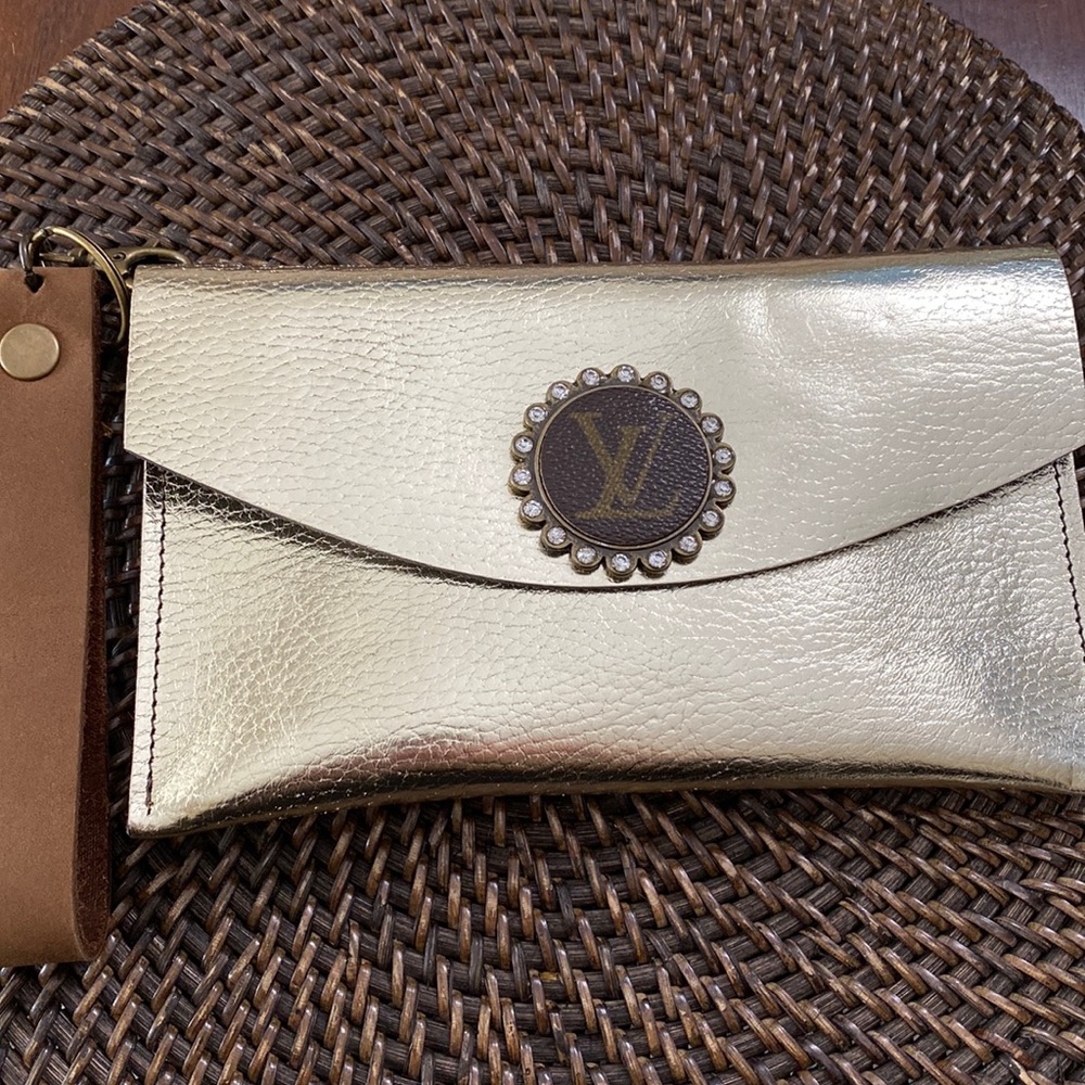 Beautiful genuine leather wristlet with an authentic Louis Vuitton button. NEW
